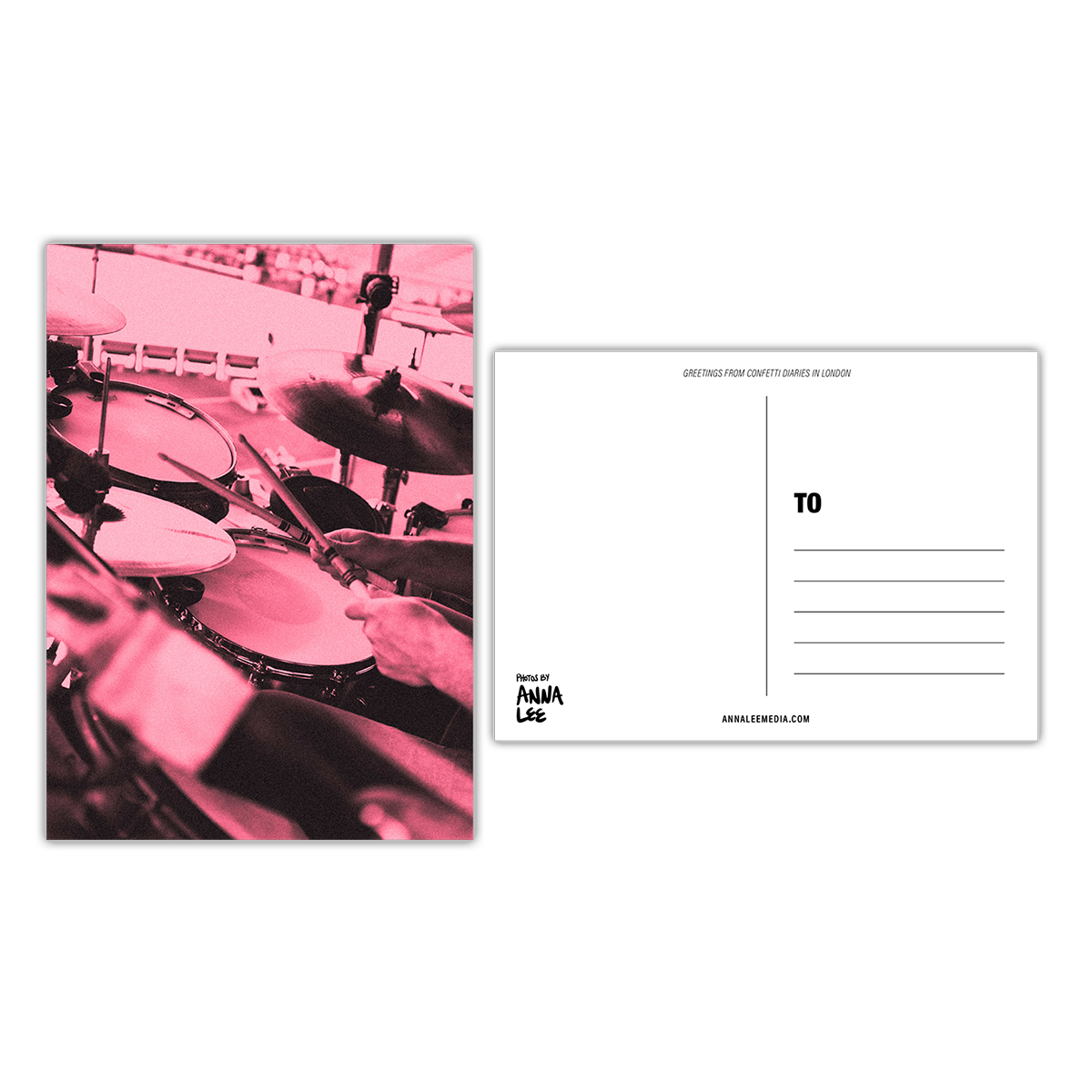 Side-by-side view of a postcard’s front and back. The front features a portrait photo close-up of Will’s hands playing the drums. His sticks are crossed over a symbol. The image is washed in a soft yet vibrant pink hue. The back, in landscape orientation, includes a writing space on the left, address lines on the right, “GREETINGS FROM CONFETTI DIARIES IN LONDON” in sloped text at the top, “Photos by Anna Lee” in the bottom right, and “Annaleemedia.com” centered below.